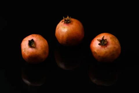 Pomegranate fruit on isolated black background Stock Photos