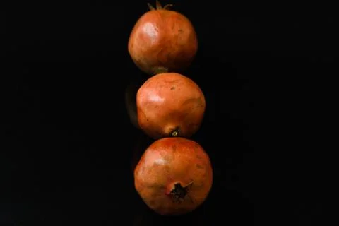 Pomegranate fruit on isolated black background Stock Photos