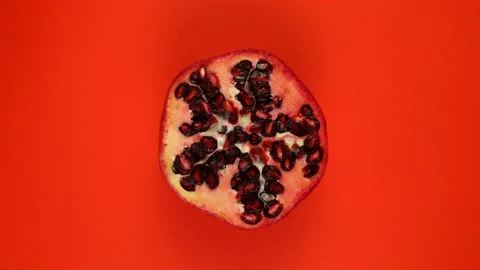Pomegranate fruit isolated on red background, rotate. Stock Footage 166743214