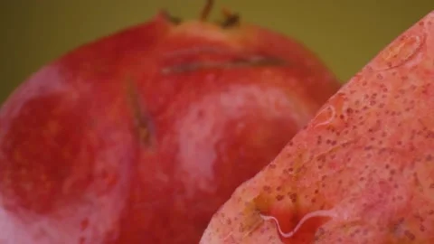 Pomegranate fruit macro shooting,isolated half kiwi on yellow background rotates Stock Footage 130995564