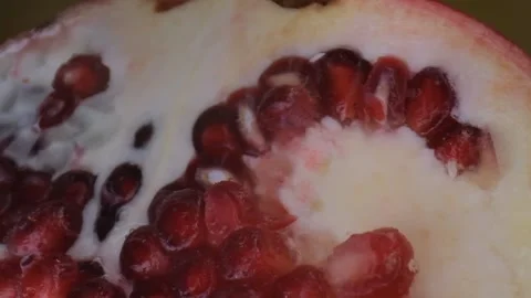 Pomegranate fruit macro shooting,isolated half kiwi on yellow background rotates Stock Footage 131603065