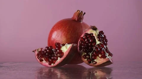 Pomegranate fruit on a pink background. Stock Footage 169331584
