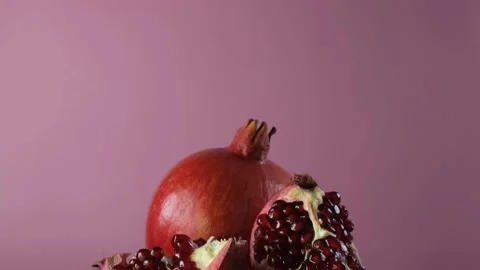 Pomegranate fruit on a pink background. Stock Footage 169331607