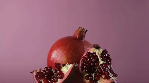 Pomegranate fruit on a pink background. Stock Footage 169331609