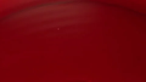 Pomegranate grains are falling down into the red juice in slow motion Stock Footage 127641559