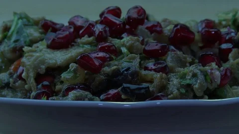 Pomegranate grains fall on fried eggplants Stock-Footage 82009326