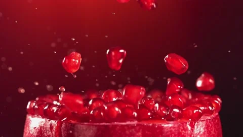 Pomegranate Grains falling on surface of half pomegranate in slow motion Stock Footage 163669936
