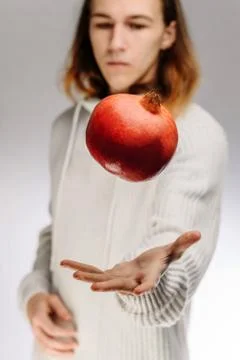 Pomegranate in hands. Stock Photos