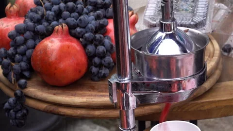 Pomegranate juice is squeezed by press. Video stock 125468250