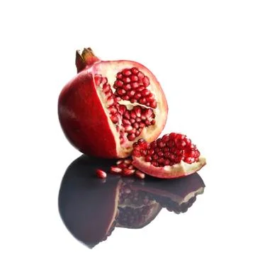 Pomegranate opened up on reflective surface Stock Photos