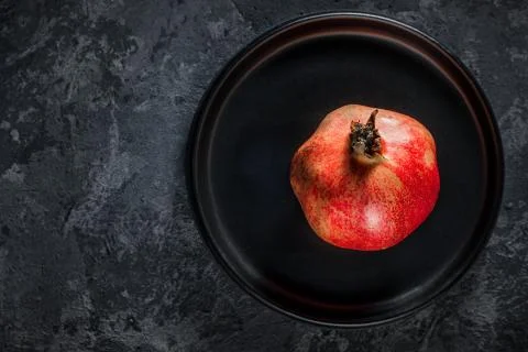 Pomegranate on a platter Stock Photos