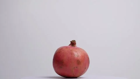 Pomegranate rotating in a studio shot Stock Footage 249947540