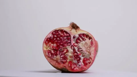 Pomegranate rotating on a table Stock Footage 249947316