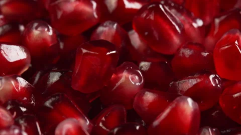 Pomegranate seeds background rotate close up top view. Ruby pomegranate grains Stock Footage 307805072