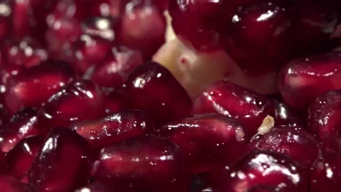 Pomegranate seeds  on a rotating surface macro shot Stock Footage 157310261