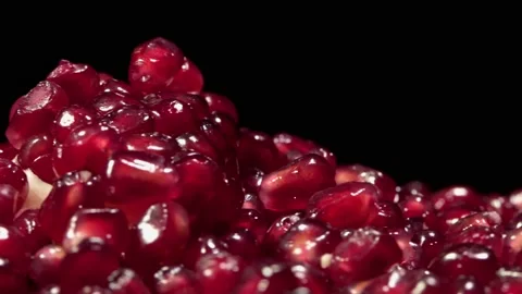 Pomegranate seeds  on a rotating surface macro shot Stock Footage 157310309