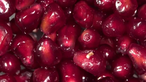 Pomegranate seeds  on a rotating surface macro shot Stock Footage 157310355