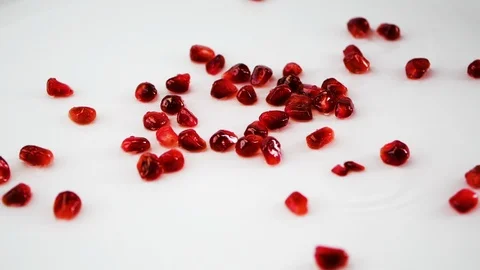 Pomegranate seeds slowly fall to the surface. Stock Footage 106919530