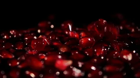 Pomegranate seeds slowly fall to the surface. Stock Footage 107128019