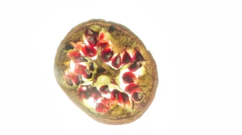Pomegranate slice  - time lapse drying out over a white back ground Stock Footage 65225454
