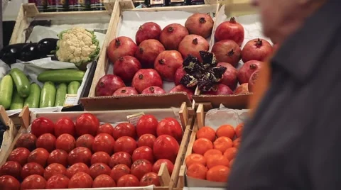 Pomegranates,persimmons and tangerines on the shelves in stores Stock Footage 59308294
