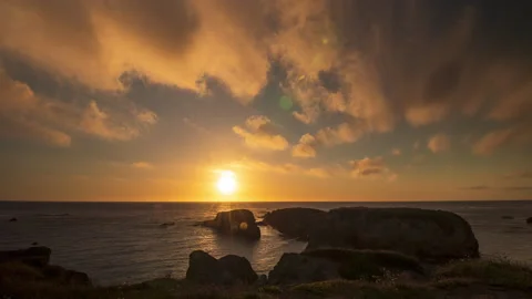 Pomo Bluffs Sunset Timelapse over Silhouetted Rocks towards the Ocean Stock Footage 218027964