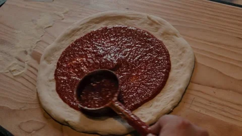 Pomodoro sauce on pizza dough medium shot Stock Footage 339843161