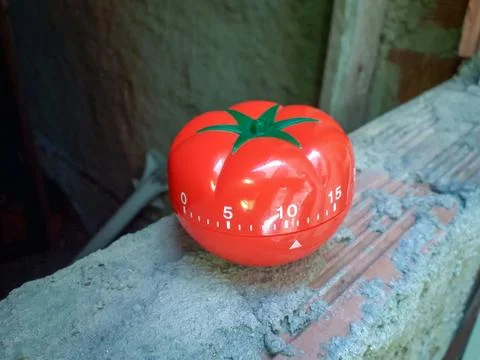Pomodoro Timer in background of old vintage brick wall. Stock Photos