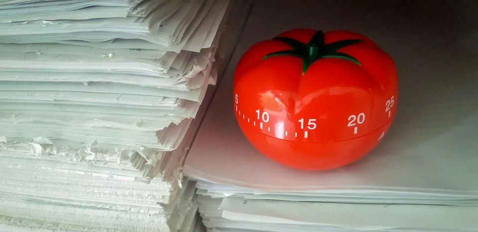Pomodoro timer in background of paper textures piled. Foto stock