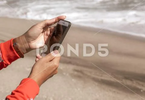 Pomorie, Bulgaria - October 06, 2018: Photo of a woman using smart phone. Stock Photos