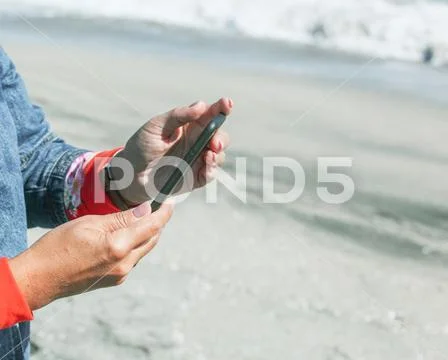 Pomorie, Bulgaria - October 06, 2018: Photo of a woman using smart phone. Stock Photos