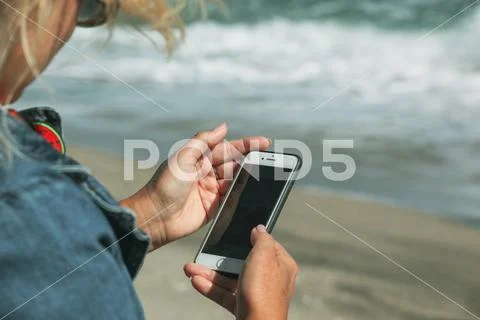 Pomorie, Bulgaria - October 06, 2018: Photo of a woman using smart phone. Stock Photos