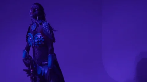 Pompous woman drow posing with a huge fantasy sword and looking away, slow Stock Footage 92019155