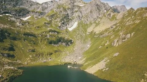 A pond against the backdrop of a huge mountain. Stock Footage 148656950