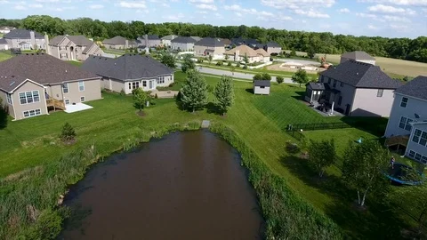 Pond behind homes Stock Footage 81725220