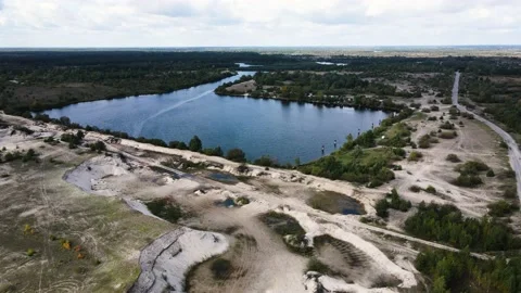 A pond with channels surrounded by trees and boat station on the side Video stock 171393655