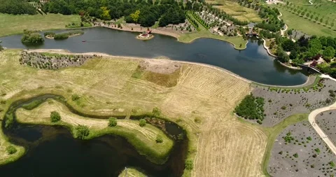 Pond with gazebo in cultivated nursery and garden of Mayfield park – aerial 4k Stock Footage 159570341