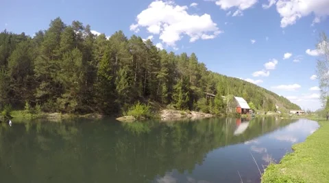 Pond with geese, white clouds in the blue sky, country house. time lapse 스톡 동영상 63346302