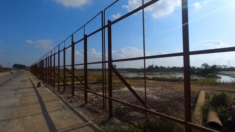 Ponds behind roadside barrier Stock Footage 123998449