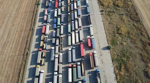 Ponlyad on top of a large queue of trucks standing in line at the port port o Stock Photos
