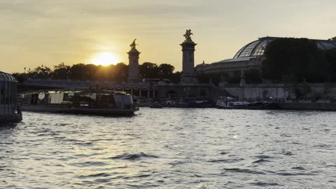 Pont Alexandre III over Seine at sunset with tourist boats in Paris Stock Footage 337196875