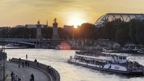 Pont Alexandre III over Seine at sunset with tourist boats in Paris Stock Footage 337196891
