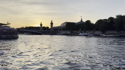 Pont Alexandre III over Seine at sunset with tourist boats in Paris Stock Footage 337196896