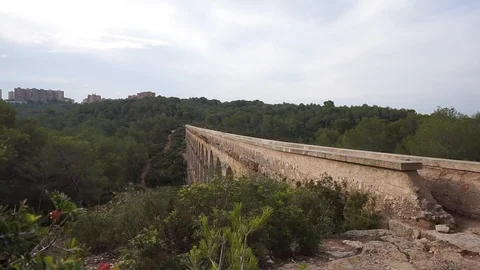 The  Pont del Diable Bridge during a summer day Stock Footage 102375816