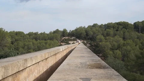 The  Pont del Diable Bridge with some tourist Stock Footage 102376051