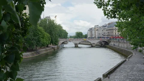 Pont Saint Michel stone bridge over Seine river with city buildings in Paris Stock Footage 337293401