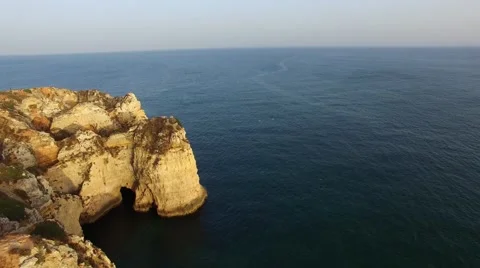 Ponta da Piedade lighthouse on cliff near ocean at sunset, Lagos, aerial view Stock Footage 64966931