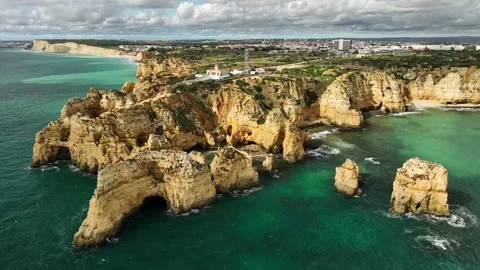 Ponta da Piedade sea stack and ocean cliff, Lagos Algarve Portugal with shore Stock Footage 347399947