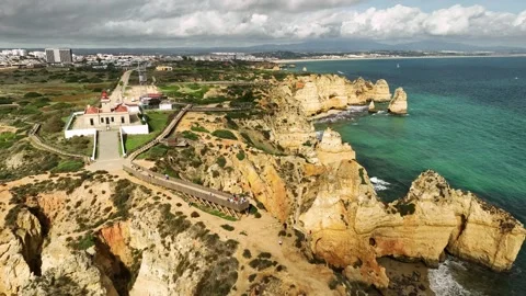 Ponta da Piedade sea stack and ocean cliff, Lagos Algarve Portugal with horizon Stock Footage 347400064