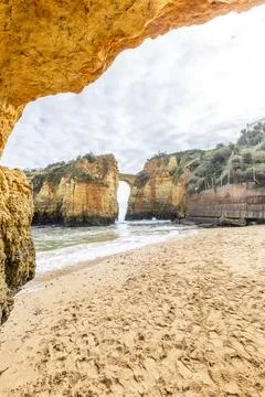 Ponte do Antigo Forte do Pinho Rock Arch at Praia dos Estudantes, Lagos, Al.. Stock Photos